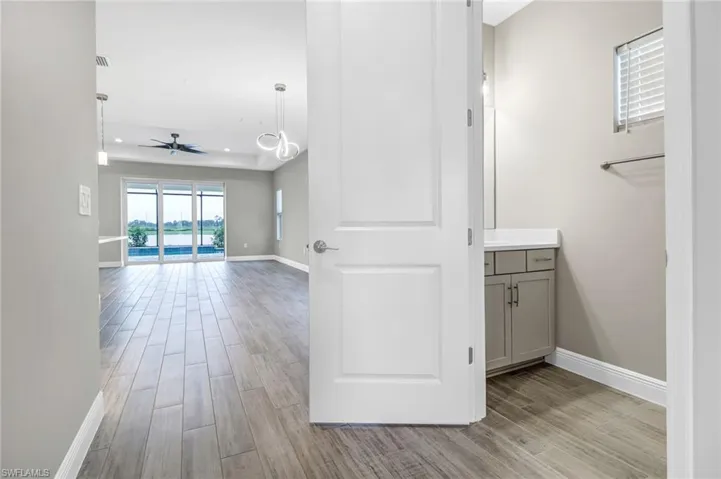 Hallway with wood tiled floors and recessed lighting
