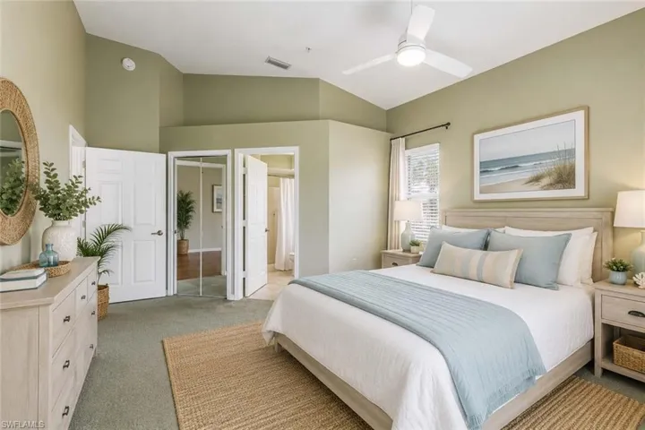 Spacious room featuring vaulted ceilings, a contemporary ceiling fan with integrated lighting, window blinds, and carpet flooring