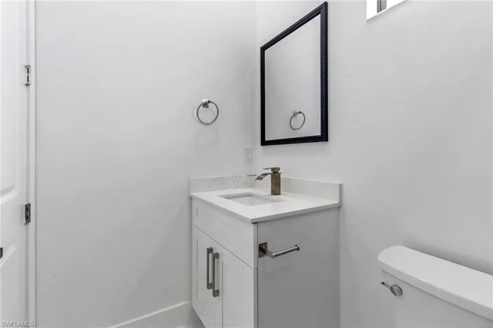 Half bath featuring toilet and vanity