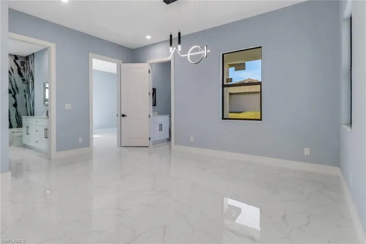 Unfurnished room with baseboards, recessed lighting, marble finish floor, and a chandelier