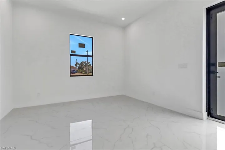 Empty room featuring recessed lighting, baseboards, and marble finish floor