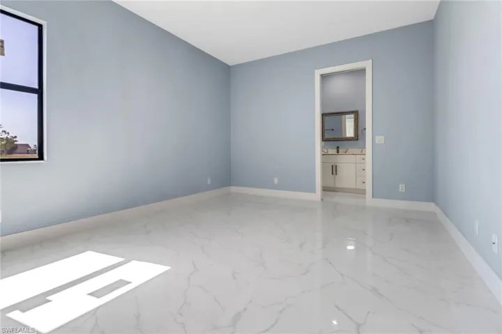 Empty room featuring baseboards and marble finish floor
