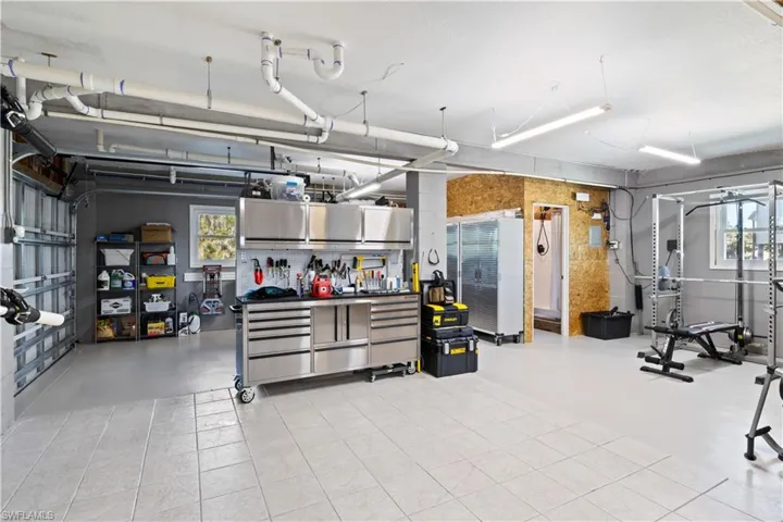 Garage features a workroom behind the garage. There is even an automatic door in the workroom that opens to the outside. Makes it a breeze to load up the boat for a day of surf and sun!