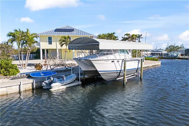 Home offers direct access to deep water and a 12,000-pound boat lift, double floating dock, and additional individual dock, perfect for your watercraft.