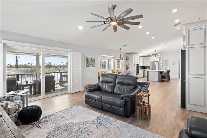 Large windows flood the space with natural light, creating a seamless connection between indoor and outdoor living, perfect for enjoying the tranquil waterfront setting.