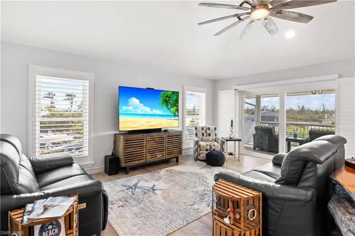 The great room offers space and provides access to the screened lanai with stunning views, plus stairs leading down to the first floor.