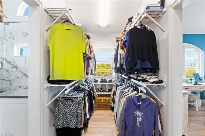 Expansive primary closet with custom shelving and an abundance of storage space.