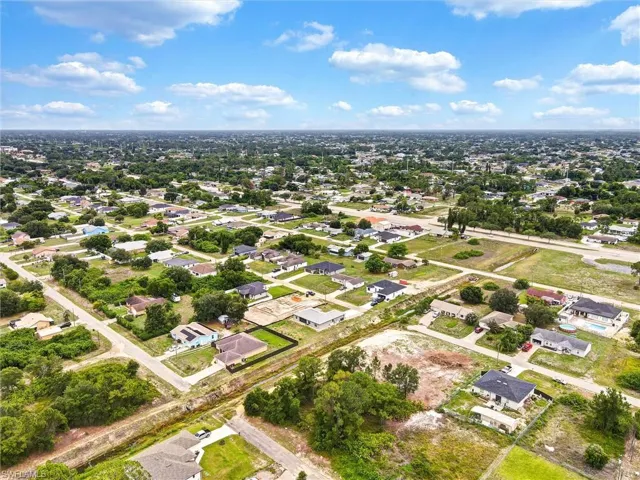 Expansive aerial view of a residential area with a mix of established homes and undeveloped lots