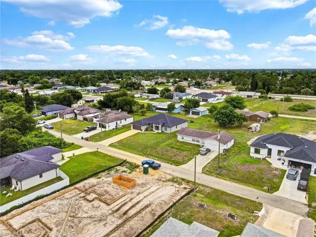 Expansive residential neighborhood featuring single-story homes with dark roofs and light-colored exteriors