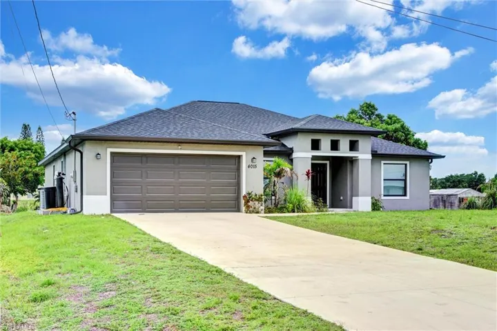 Contemporary stucco exterior with a dark shingle roof, a two-car garage, and a concrete driveway