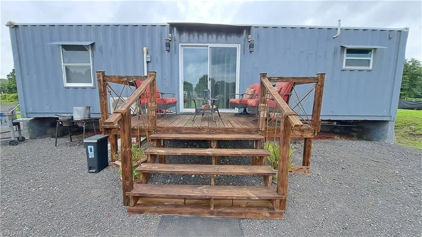 View of exterior entry with a wooden deck