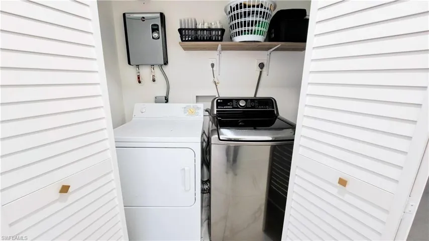 Laundry room with washer and clothes dryer