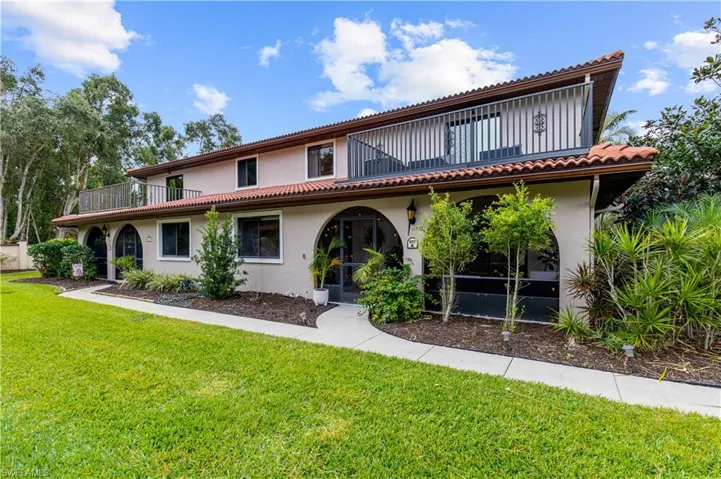 Mediterranean / spanish house featuring a balcony and a front yard