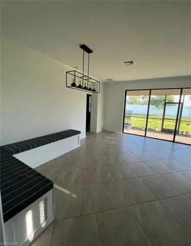 Unfurnished dining area with dark tile patterned floors