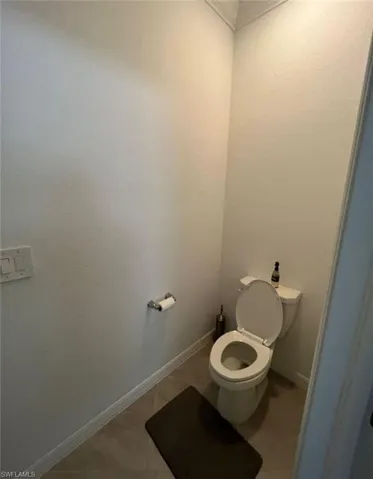 Bathroom featuring toilet and baseboards