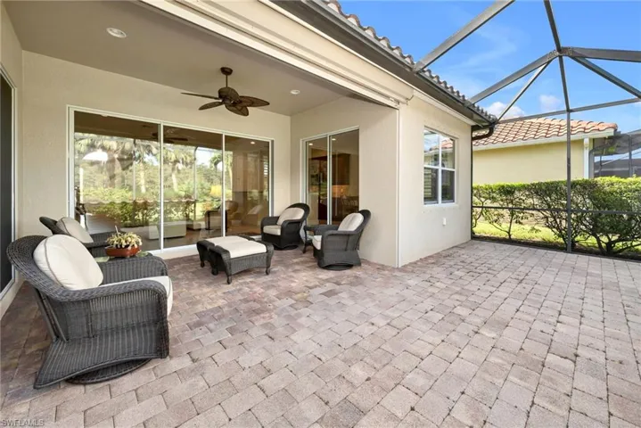 View of patio / terrace with an outdoor hangout area, glass enclosure, and ceiling fan