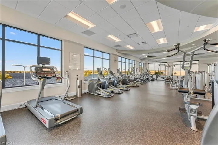 Exercise room with a paneled ceiling and a water view