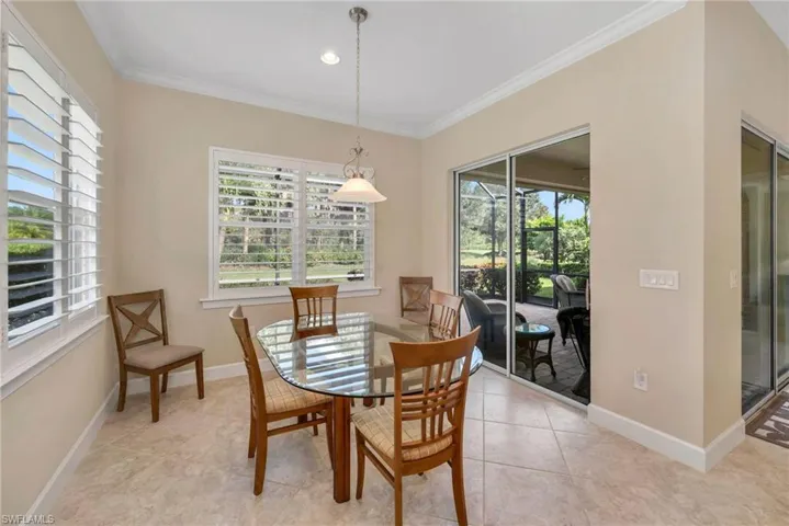 Tiled dining space with ornamental molding and a wealth of natural light