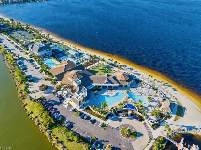 Birds eye view of property with a view of the beach and a water view