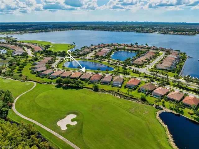Birds eye view of property with a water view