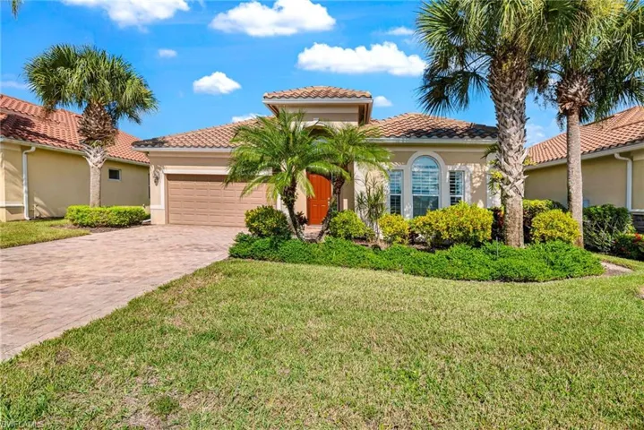 Mediterranean / spanish house with a front yard and a garage