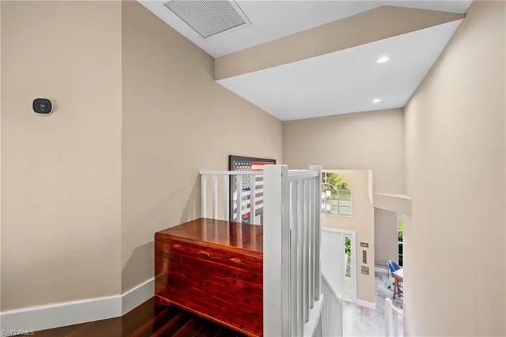 Hallway with recessed lighting and wood finished floors