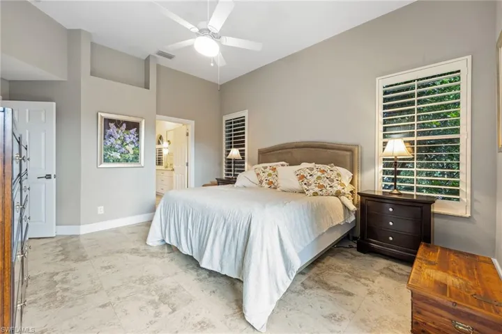 Bedroom with a ceiling fan and ensuite bathroom