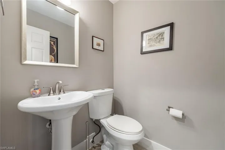 Bathroom with toilet and baseboards