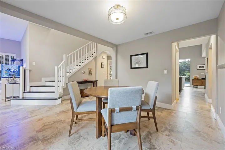 Dining room featuring stairs and arched walkways