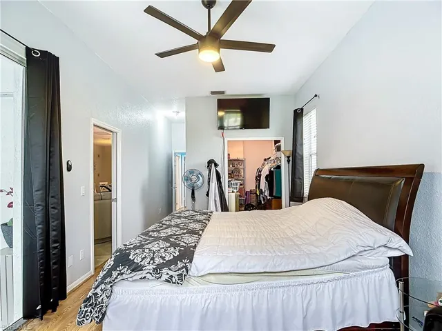 Second Guest Bedroom with ceiling fan, a closet, light wood-type flooring, and a spacious closet
