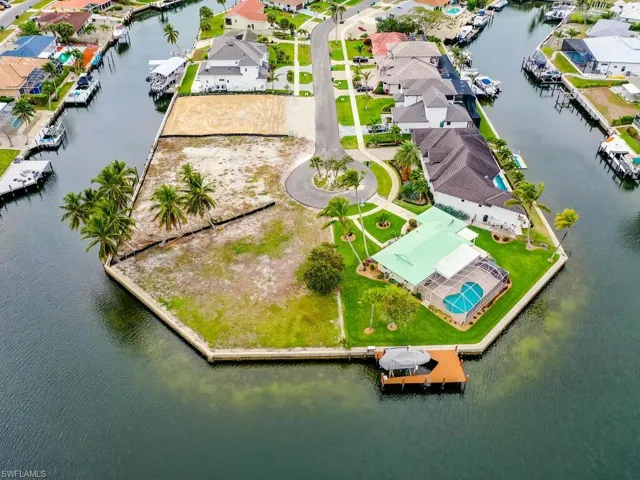 Birds eye view of property with a water view and a residential view