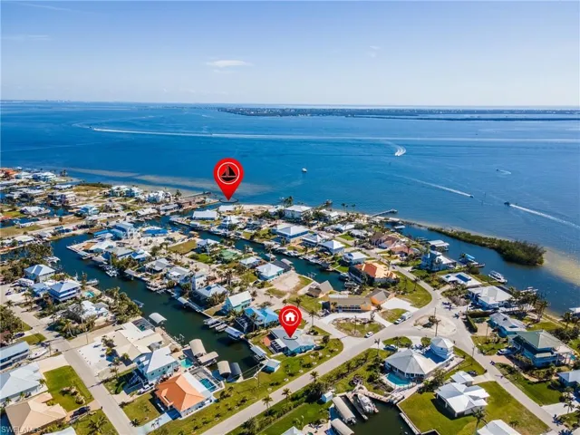 Birds eye view of property with a water view