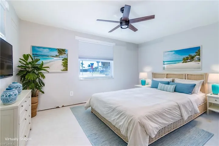 Bedroom featuring ceiling fan (virtually staged)