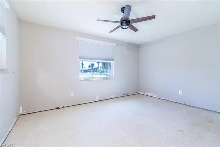 Unfurnished room featuring ceiling fan