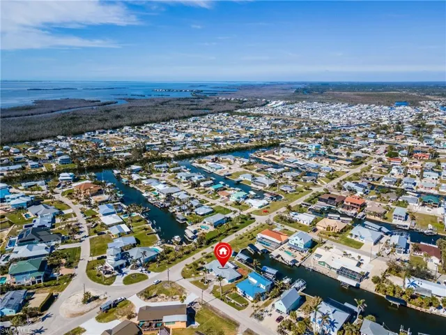 Birds eye view of property with a water view