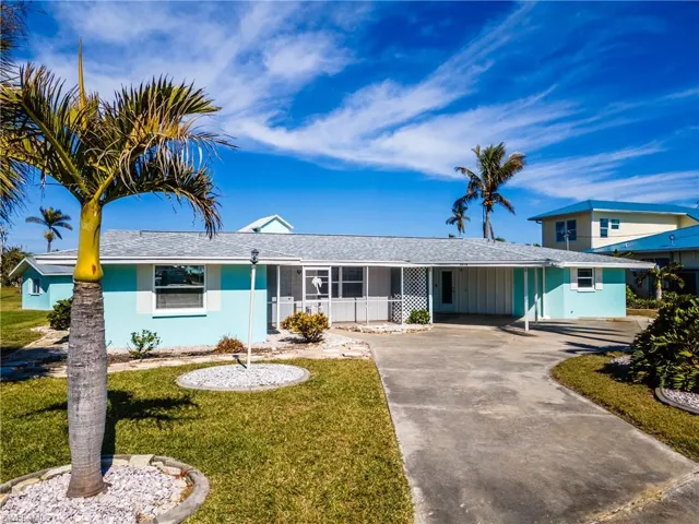 View of front of house featuring a front lawn and a carport