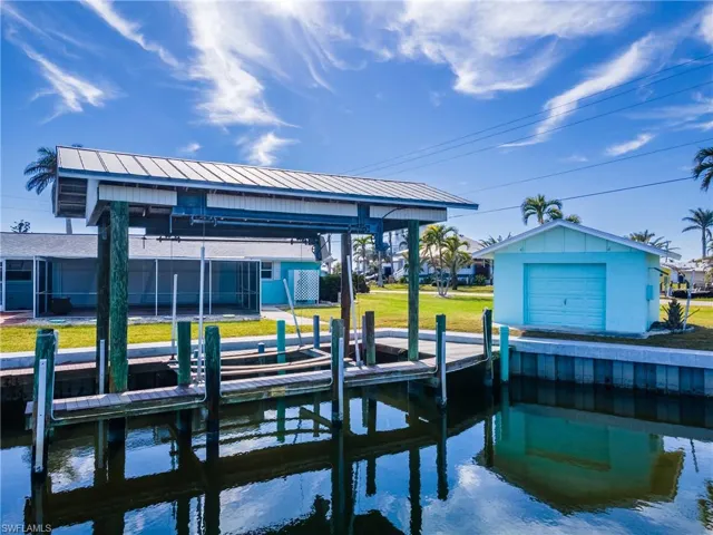 Dock area with a lawn and a water view