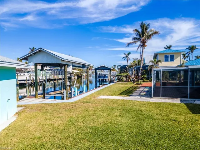 View of dock featuring a water view and a lawn