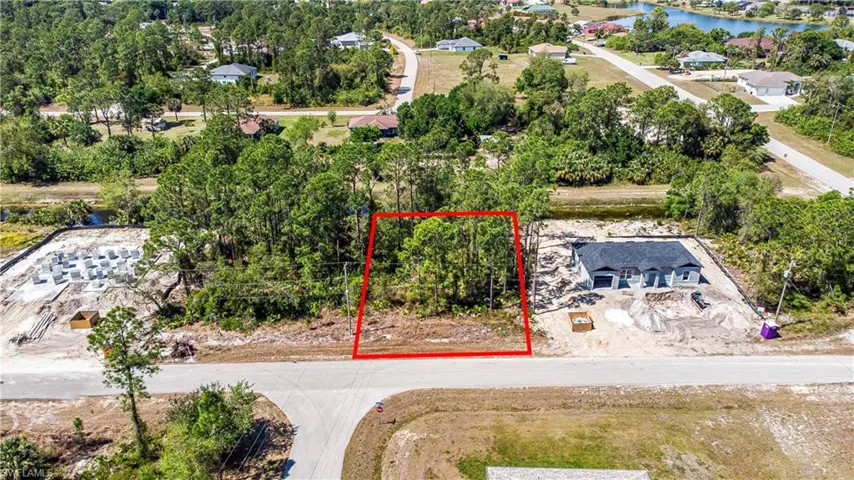 Aerial view of property's location featuring property parcel outlined and a nearby body of water