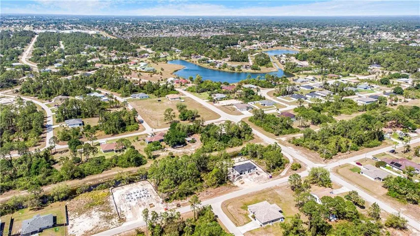 Aerial view of residential area featuring a large body of water