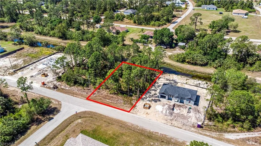 Aerial view of property's location featuring property boundaries highlighted and a tree filled landscape