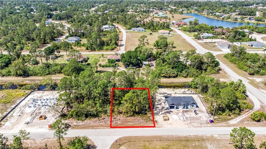 Aerial view of property's location featuring property parcel outlined and a large body of water