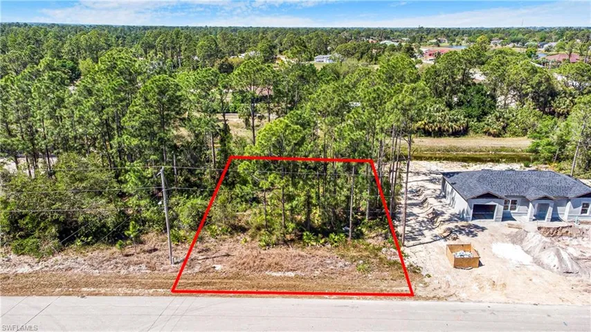 Aerial view of property and surrounding area featuring property parcel outlined