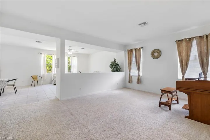 Unfurnished room featuring light colored carpet and light tile patterned floors