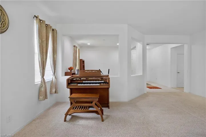 Sitting room featuring light colored carpet