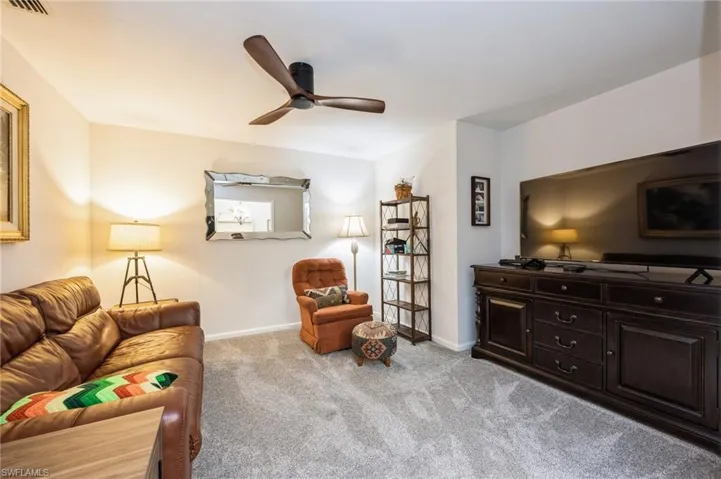 Living room with ceiling fan and carpet flooring