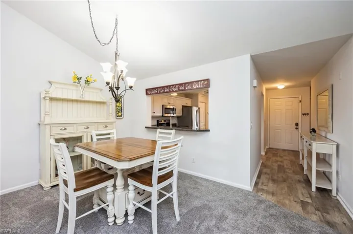 Dining room featuring a chandelier and dark hardwood / wood-style floors
