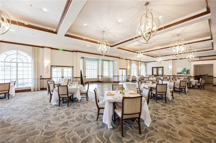 Dining room featuring an inviting chandelier, carpet, and a tray ceiling