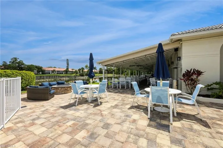 View of patio with an outdoor living space with a fire pit