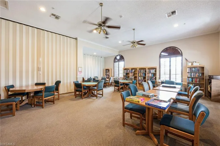 Dining space with a textured ceiling, plenty of natural light, ceiling fan, and carpet floors